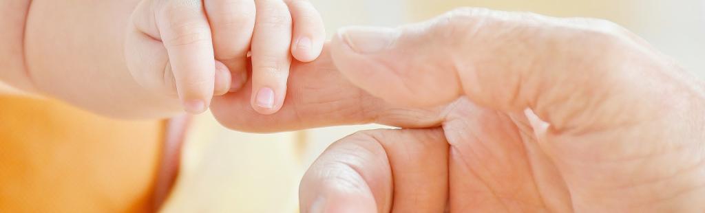 Baby holding finger